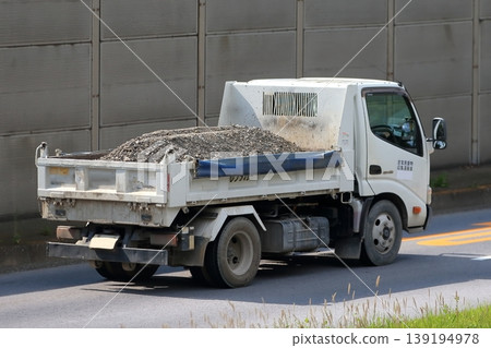 A 4-ton dump truck transporting crushed stone. 139194978