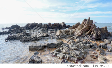 Rugged Dark Rock Formations on Tropical Shoreline Rugged Dark Rock Formations on Tropical Shoreline 139195202