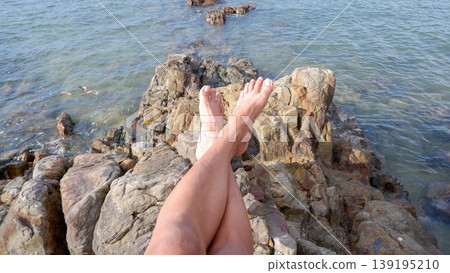 Relaxing on Coastal Rocks at Tanjung Ular Beach Relaxing on Coastal Rocks at Tanjung Ular Beach 139195210