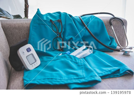 Healthcare worker uniform with medical equipment on sofa Healthcare worker uniform with medical equipment on sofa 139195978