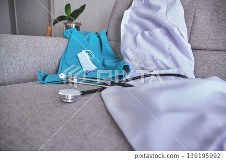 Medical scrubs, lab coat, stethoscope representing healthcare profession 139195992