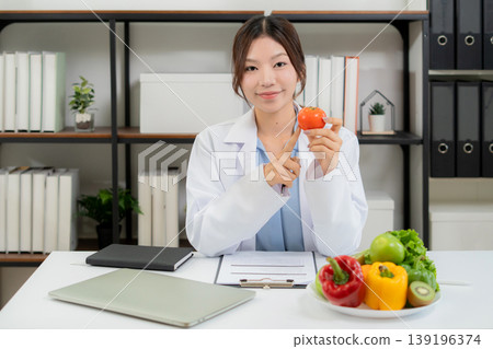 Portrait asian woman nutritionist working in medical clinic office. Portrait asian woman nutritionist working in medical clinic office. 139196374