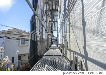 Scaffolding walkway and new exterior siding for a detached house Scaffolding walkway and new exterior siding for a detached house 139196388