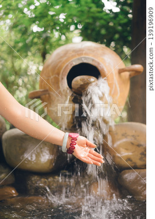 an asian woman is playing in a hot spring pool an asian woman is playing in a hot spring pool 139196909