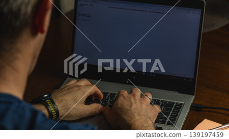Hands typing on laptop with blank screen in home office workspace Hands typing on laptop with blank screen in home office workspace 139197459