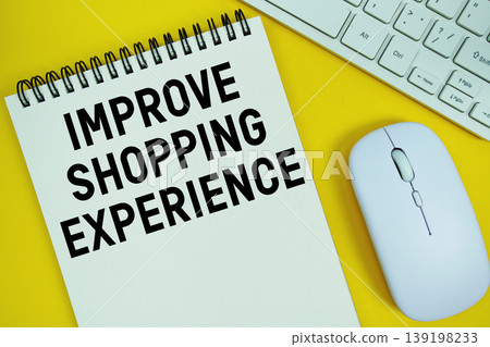 Notepad with the text "Improve Shopping Experience" and white keyboard and wireless mouse on yellow background 139198233
