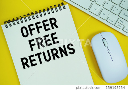 Notepad with the text "Offer Free Returns" and white keyboard and wireless mouse on yellow background Notepad with the text "Offer Free Returns" and white keyboard and wireless mouse on yellow background 139198234