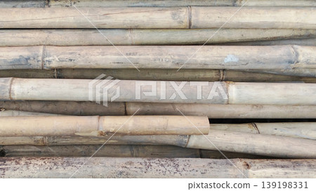 Textured Background of Stacked Bamboo Poles with Natural Wood Grain and Rustic Cream Shades Textured Background of Stacked Bamboo Poles with Natural Wood Grain and Rustic Cream Shades 139198331