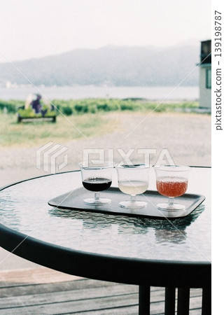 Wine tasting on a terrace overlooking the sea and vineyards. Wine tasting on a terrace overlooking the sea and vineyards. 139198787