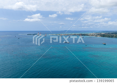 A scene of marine construction work and a construction vessel in Oura Bay, Okinawa Prefecture (drone aerial photography) 139199065