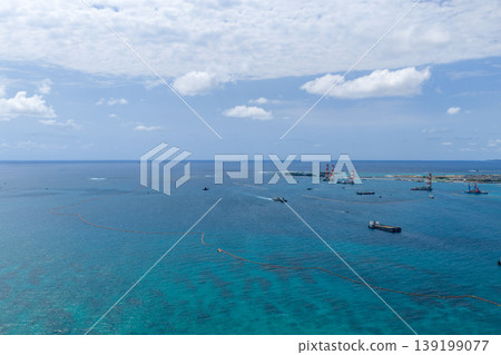 A scene of marine construction work and a construction vessel in Oura Bay, Okinawa Prefecture (drone aerial photography) 139199077