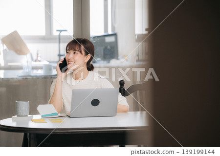 Beautiful young asian woman smiling happily during remote business work and study at home using laptop Beautiful young asian woman smiling happily during remote business work and study at home using laptop 139199144