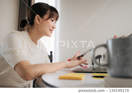 Smiling young asian woman enjoying remote work at home doing business and study online using modern laptop computer Smiling young asian woman enjoying remote work at home doing business and study online using modern laptop computer 139199178