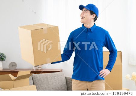 A young man working in the moving industry; lifestyle image A young man working in the moving industry; lifestyle image 139199473