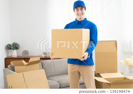 A young man working in the moving industry; lifestyle image 139199474