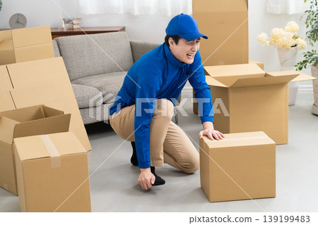 A young man working in the moving industry; lifestyle image A young man working in the moving industry; lifestyle image 139199483