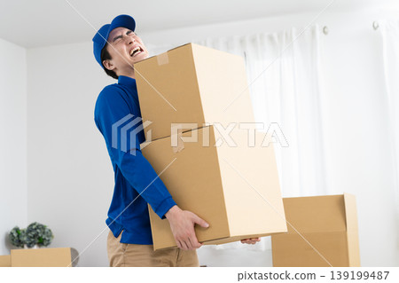 A young man working in the moving industry; lifestyle image A young man working in the moving industry; lifestyle image 139199487