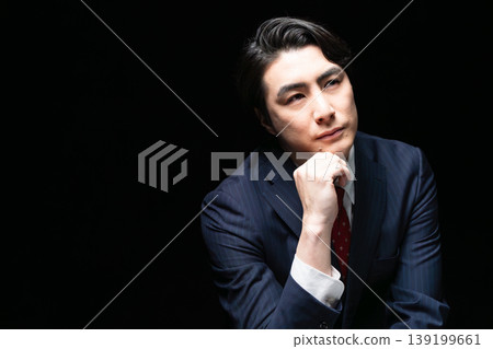 A young man in a business suit; a business image. A young man in a business suit; a business image. 139199661
