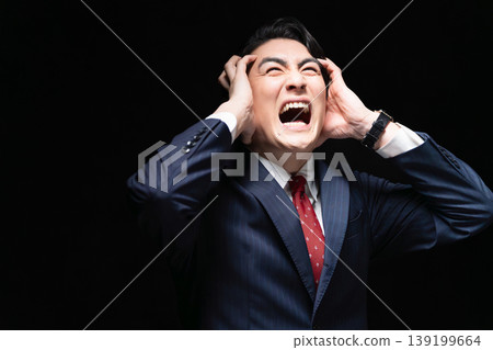 A young man in a business suit; a business image. A young man in a business suit; a business image. 139199664