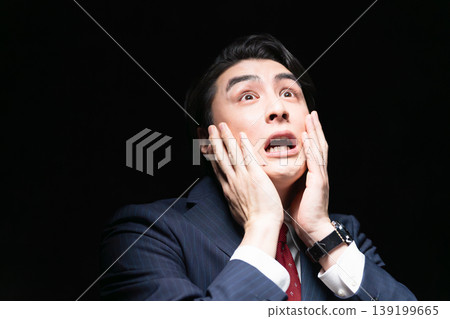 A young man in a business suit; a business image. A young man in a business suit; a business image. 139199665