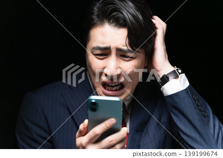 A young man in a business suit; a business image. A young man in a business suit; a business image. 139199674