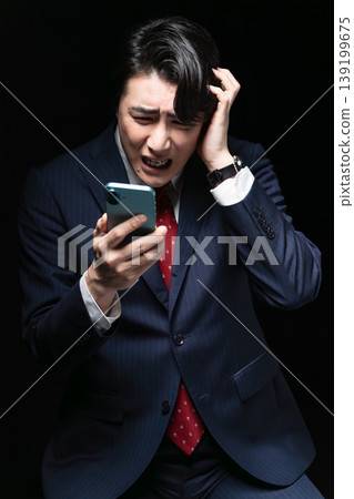 A young man in a business suit; a business image. A young man in a business suit; a business image. 139199675