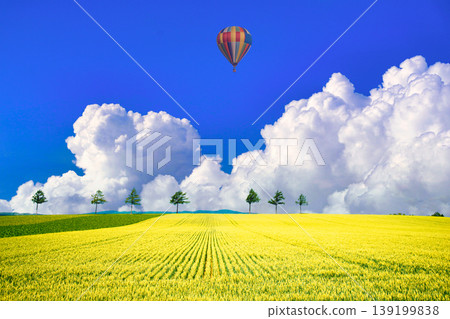 A composite image of the beautiful rural landscape of Memanbetsu and towering cumulonimbus clouds. A composite image of the beautiful rural landscape of Memanbetsu and towering cumulonimbus clouds. 139199838