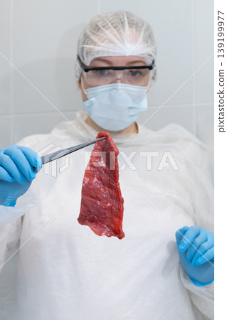Technician Conducts Detailed Inspection Of Uncooked Beef Using Protective Gear And Sampling Tools Technician Conducts Detailed Inspection Of Uncooked Beef Using Protective Gear And Sampling Tools 139199977