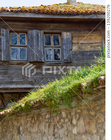 a vintage Bulgarian seaside house with wooden siding and tiled roof a vintage Bulgarian seaside house with wooden siding and tiled roof 139200276