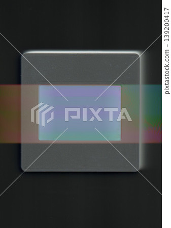 Minimalist conceptual art of a vintage film slide with a prismatic light leak and glitch effect on a black background, representing analog nostalgia and modern digital distortion trends. 139200417