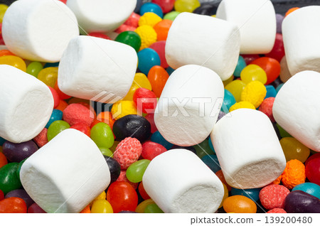 Lots of colorful round colored candies and white marshmallows top view Lots of colorful round colored candies and white marshmallows top view 139200480