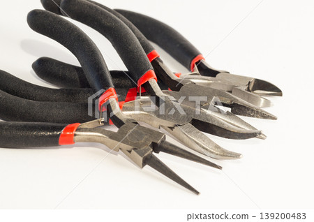 Set of different types of pliers and side cutters isolated on black background. Set of different types of pliers and side cutters isolated on black background. 139200483