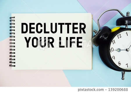 Declutter Your Life text written on notepad with alarm clock flat lay on multicolor pastel background Declutter Your Life text written on notepad with alarm clock flat lay on multicolor pastel background 139200688