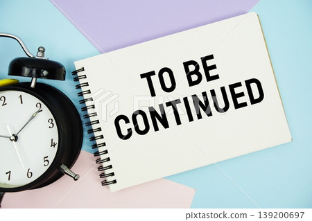 To Be Continued text written on notepad with alarm clock flat lay on multicolor pastel background To Be Continued text written on notepad with alarm clock flat lay on multicolor pastel background 139200697