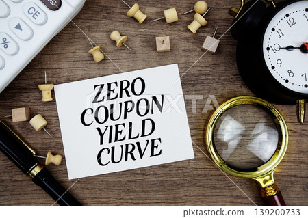 Zero Coupon Yield Curve text written on notepad with pen, alarm clock, magnifying glass and calculator on wooden background 139200733