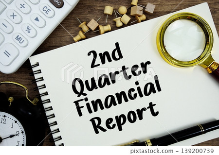 2nd Quarter Financial Report text written on notepad with pen, alarm clock, magnifying glass and calculator on wooden background 139200739