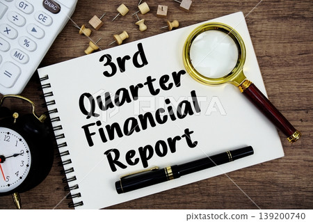 3rd Quarter Financial Report text written on notepad with pen, alarm clock, magnifying glass and calculator on wooden background 3rd Quarter Financial Report text written on notepad with pen, alarm clock, magnifying glass and calculator on wooden background 139200740