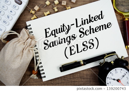 Equity-Linked Savings Scheme (ELSS) text written on notepad with pen, alarm clock, magnifying glass and calculator on wooden background 139200743