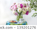 bouquet of white daisy flowers in a wicker basket on a wooden background, copy space 139201276