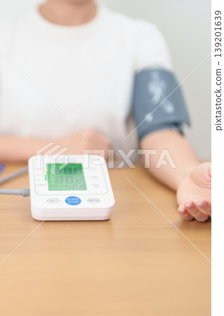woman checking Blood pressure by Blood pressure monitor with Cuff. Systolic, SYS, Diastolic, DIA, Pulse, Hypertension, Hypotension, Heart rate, Cardiovascular Disease and May World hypertension day woman checking Blood pressure by Blood pressure monitor with Cuff. Systolic, SYS, Diastolic, DIA, Pulse, Hypertension, Hypotension, Heart rate, Cardiovascular Disease and May World hypertension day 139201639