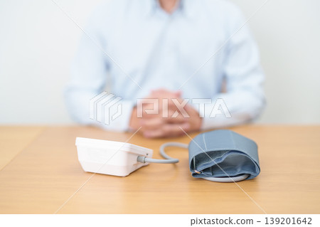 Man checking Blood pressure by Blood pressure monitor with Cuff. Systolic, SYS, Diastolic, DIA, Pulse, Hypertension, Hypotension, Heart rate, Cardiovascular Disease and May World hypertension day Man checking Blood pressure by Blood pressure monitor with Cuff. Systolic, SYS, Diastolic, DIA, Pulse, Hypertension, Hypotension, Heart rate, Cardiovascular Disease and May World hypertension day 139201642