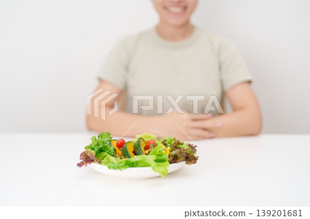 happy smiling woman with fresh organic vegetables plate. healthy nutrition, weight loss, clean eating, Healthy food eating, Vegan, Wellness, Green dieting and Healthy lifestyle 139201681