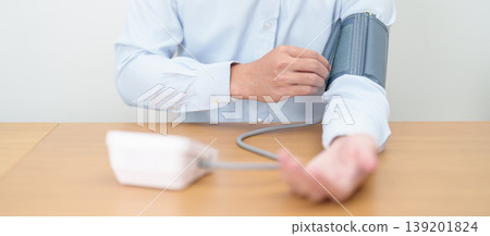 Man checking Blood pressure by Blood pressure monitor with Cuff. Systolic, SYS, Diastolic, DIA, Pulse, Hypertension, Hypotension, Heart rate, Cardiovascular Disease and May World hypertension day Man checking Blood pressure by Blood pressure monitor with Cuff. Systolic, SYS, Diastolic, DIA, Pulse, Hypertension, Hypotension, Heart rate, Cardiovascular Disease and May World hypertension day 139201824