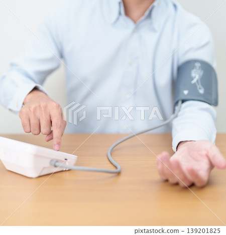 Man checking Blood pressure by Blood pressure monitor with Cuff. Systolic, SYS, Diastolic, DIA, Pulse, Hypertension, Hypotension, Heart rate, Cardiovascular Disease and May World hypertension day Man checking Blood pressure by Blood pressure monitor with Cuff. Systolic, SYS, Diastolic, DIA, Pulse, Hypertension, Hypotension, Heart rate, Cardiovascular Disease and May World hypertension day 139201825