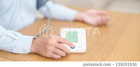 Man checking Blood pressure by Blood pressure monitor with Cuff. Systolic, SYS, Diastolic, DIA, Pulse, Hypertension, Hypotension, Heart rate, Cardiovascular Disease and May World hypertension day Man checking Blood pressure by Blood pressure monitor with Cuff. Systolic, SYS, Diastolic, DIA, Pulse, Hypertension, Hypotension, Heart rate, Cardiovascular Disease and May World hypertension day 139201830