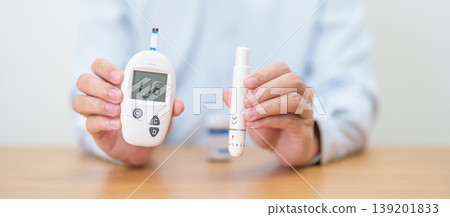 Hand checking Diabetes or Blood glucose self testing by digital blood glucose meter with lancet pen. high blood sugar level, World Diabetes Day, Glycemia, Hypoglycemia, Hyperglycemia and insulin Hand checking Diabetes or Blood glucose self testing by digital blood glucose meter with lancet pen. high blood sugar level, World Diabetes Day, Glycemia, Hypoglycemia, Hyperglycemia and insulin 139201833