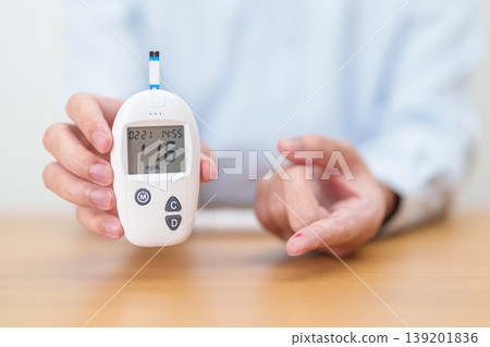 Hand checking Diabetes or Blood glucose self testing by digital blood glucose meter with lancet pen. high blood sugar level, World Diabetes Day, Glycemia, Hypoglycemia, Hyperglycemia and insulin Hand checking Diabetes or Blood glucose self testing by digital blood glucose meter with lancet pen. high blood sugar level, World Diabetes Day, Glycemia, Hypoglycemia, Hyperglycemia and insulin 139201836