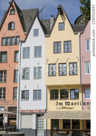 Cologne, Germany - July 07, 2018: Fountain "Fish shops" against a backdrop of beautiful houses in the center of Cologne Cologne, Germany - July 07, 2018: Fountain "Fish shops" against a backdrop of beautiful houses in the center of Cologne 139202847