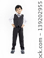 Happy boy standing over white background 139202955