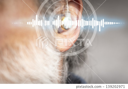 Mature man with hearing aid in the background, sound wave simulation technology. Closing Mature man with hearing aid in the background, sound wave simulation technology. Closing 139202971